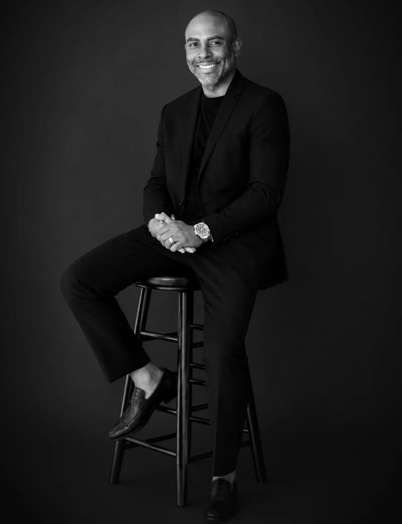 Attorney Micah E. Huggins, seated, black-and-white portrait